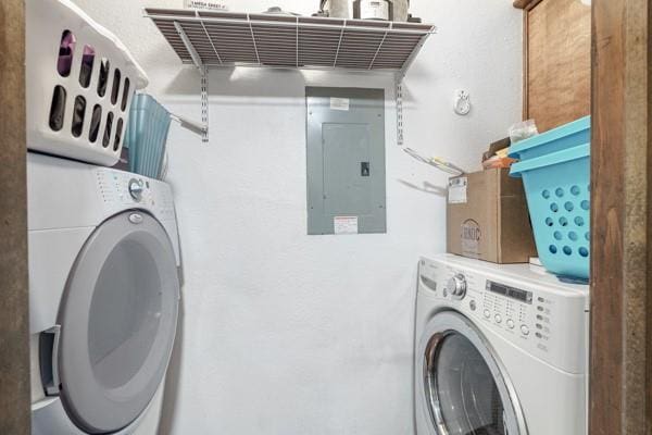 laundry area with laundry area, washing machine and dryer, and electric panel