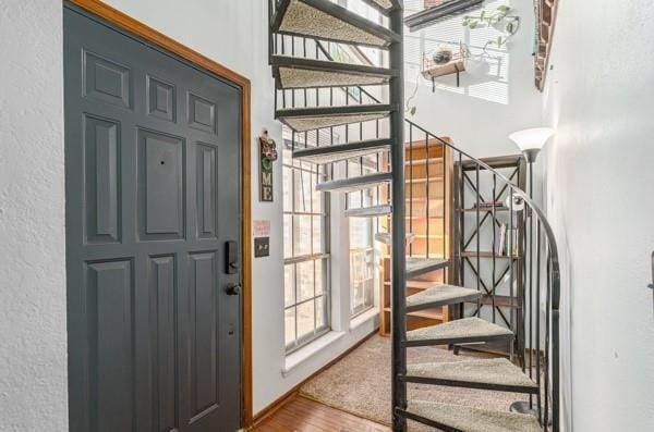 stairway featuring wood finished floors and baseboards