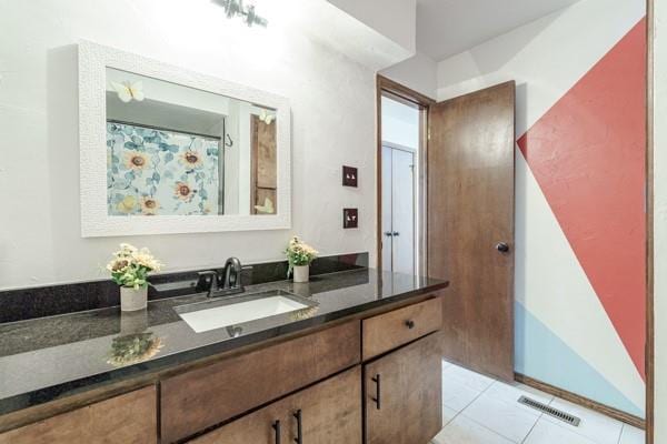 bathroom with tile patterned flooring, vanity, and visible vents