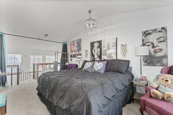 bedroom featuring vaulted ceiling and an inviting chandelier