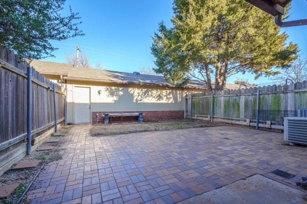 view of patio with a fenced backyard and central air condition unit