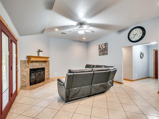 living area with lofted ceiling, light tile patterned flooring, visible vents, and baseboards