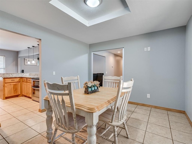 dining space with light tile patterned floors and baseboards