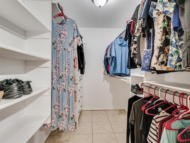 spacious closet with light tile patterned floors