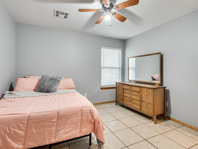 bedroom with baseboards, visible vents, a ceiling fan, and light tile patterned flooring