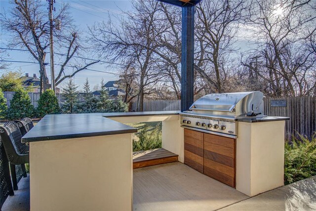 1212 W Wilshire Blvd, Nichols Hills, OK 73116 - view of patio with exterior kitchen, grilling area, a fenced backyard, and a carport