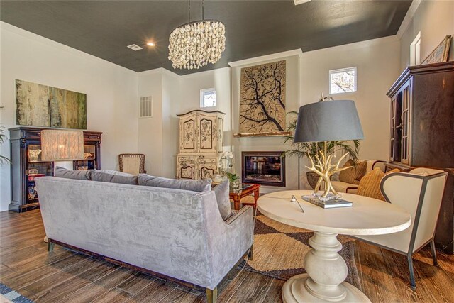 1212 W Wilshire Blvd, Nichols Hills, OK 73116 - living room with a glass covered fireplace, a chandelier, and dark wood-style flooring