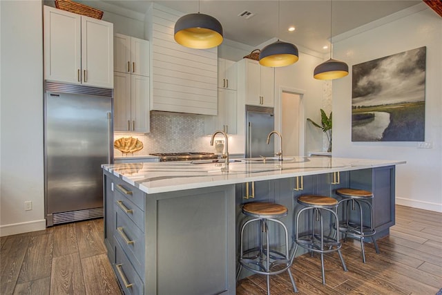 1212 W Wilshire Blvd, Nichols Hills, OK 73116 - kitchen with stainless steel built in fridge, baseboards, dark wood-style floors, and recessed lighting