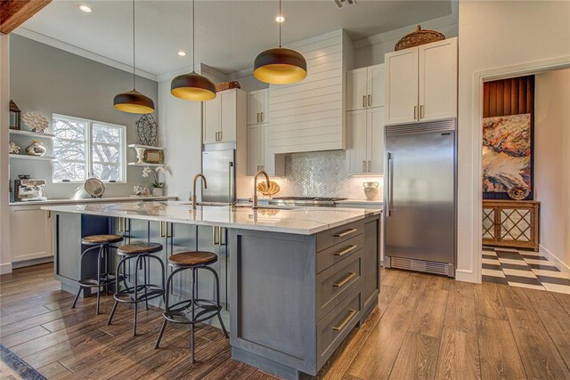 1212 W Wilshire Blvd, Nichols Hills, OK 73116 - kitchen featuring stainless steel built in fridge, gray cabinetry, open shelves, wood finished floors, and recessed lighting