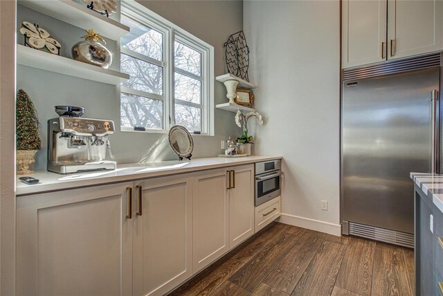 1212 W Wilshire Blvd, Nichols Hills, OK 73116 - kitchen with stainless steel appliances, open shelves, dark wood-type flooring, light countertops, and healthy amount of natural light