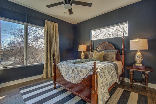 1212 W Wilshire Blvd, Nichols Hills, OK 73116 - bedroom with multiple windows, wood finished floors, baseboards, and a ceiling fan