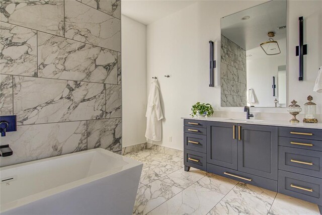 1212 W Wilshire Blvd, Nichols Hills, OK 73116 - bathroom featuring marble tiled floors, a bathtub, and vanity