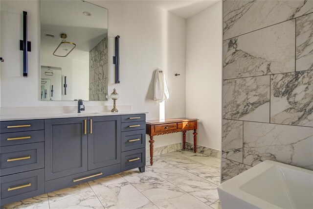 1212 W Wilshire Blvd, Nichols Hills, OK 73116 - bathroom with marble look tiles, a bathtub, and vanity