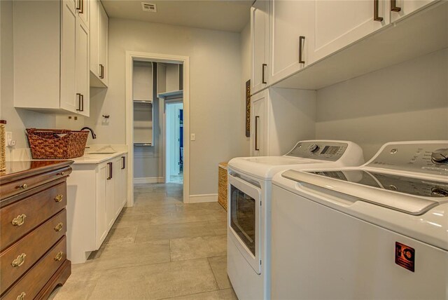 1212 W Wilshire Blvd, Nichols Hills, OK 73116 - washroom featuring washer and dryer, cabinet space, and baseboards