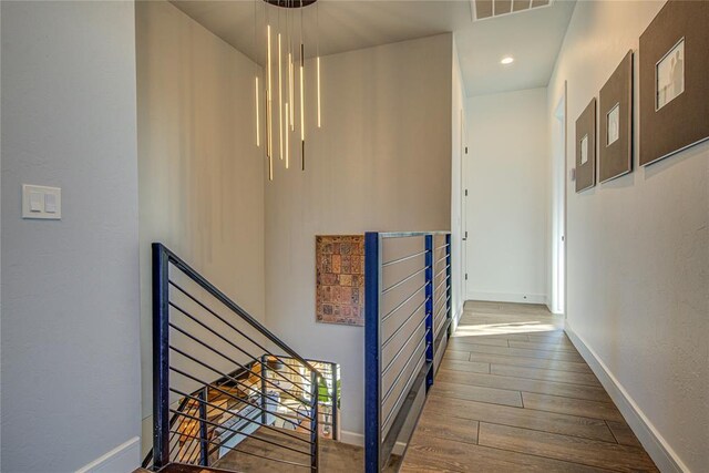 1212 W Wilshire Blvd, Nichols Hills, OK 73116 - hallway featuring an upstairs landing, wood finished floors, baseboards, and recessed lighting