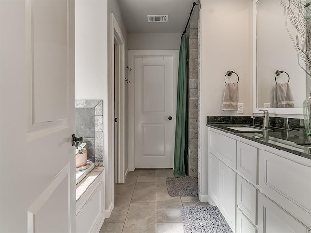 full bathroom featuring a shower with curtain, vanity, visible vents, and tile patterned floors