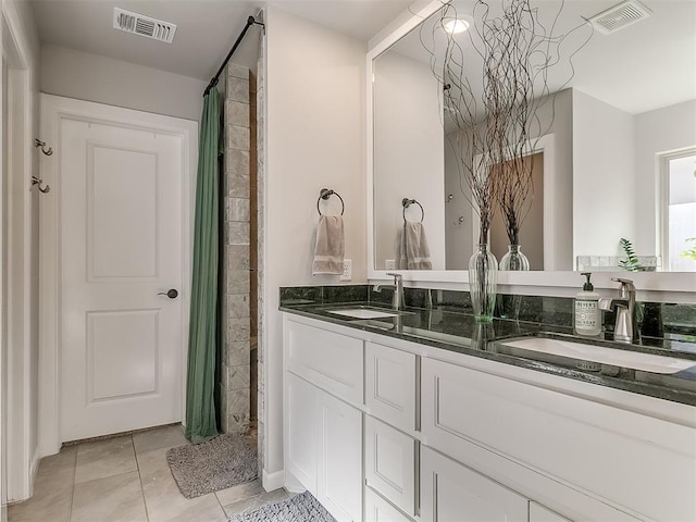 full bathroom with a sink, visible vents, and tile patterned floors