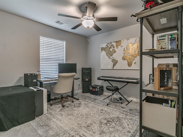 office space featuring visible vents, ceiling fan, and baseboards