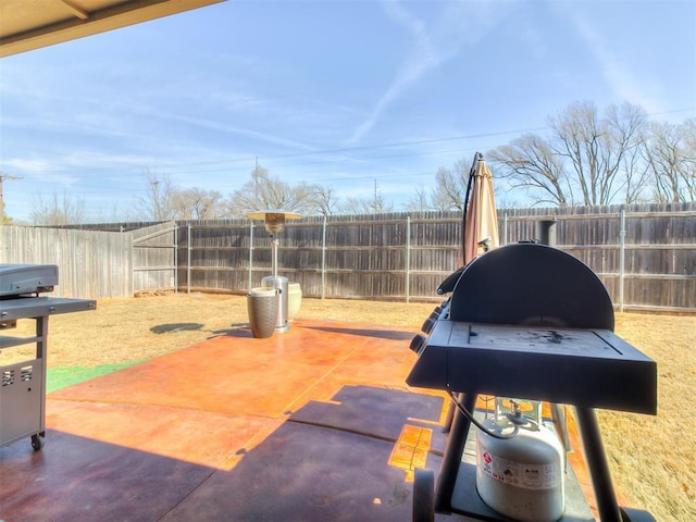 view of patio with a fenced backyard and a grill