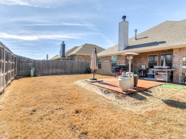 view of yard featuring a patio area and a fenced backyard