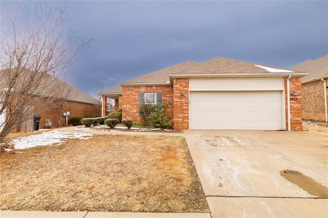 ranch-style house featuring a garage, concrete driveway, and brick siding