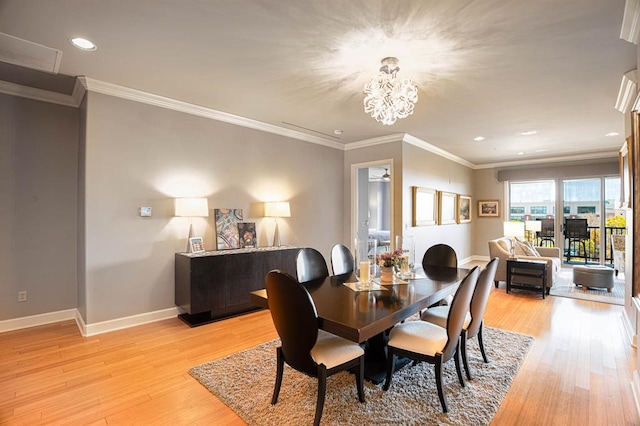 dining room featuring baseboards, crown molding, light wood-type flooring, a notable chandelier, and recessed lighting