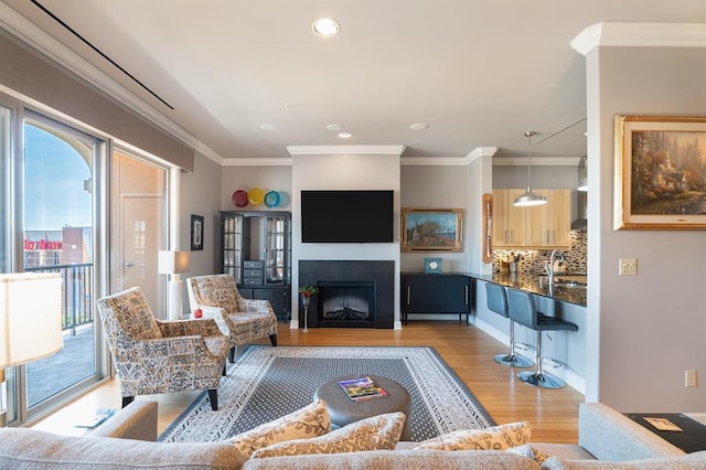 200 S Oklahoma Ave Unit 305, Oklahoma City, OK 73104 - living room with light wood finished floors, ornamental molding, a fireplace, and recessed lighting