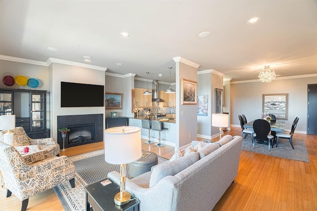 200 S Oklahoma Ave Unit 305, Oklahoma City, OK 73104 - living room with a fireplace, recessed lighting, light wood-style flooring, ornamental molding, and a chandelier