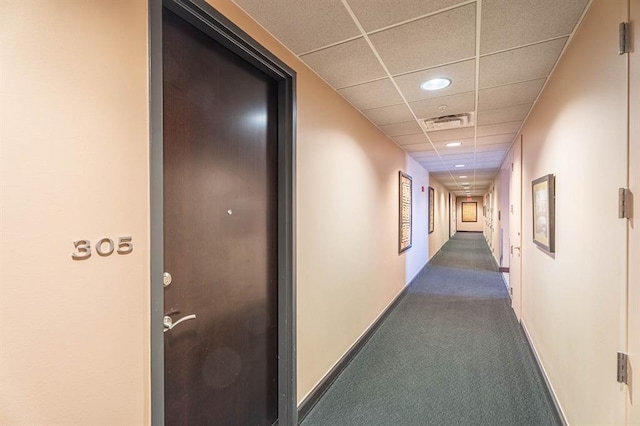 200 S Oklahoma Ave Unit 305, Oklahoma City, OK 73104 - hallway featuring a paneled ceiling, dark carpet, and recessed lighting