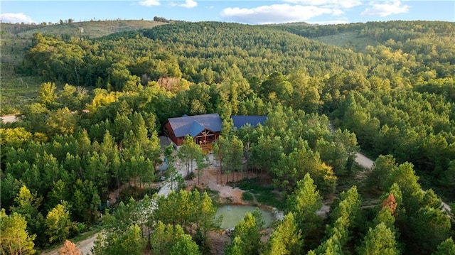 birds eye view of property featuring a view of trees