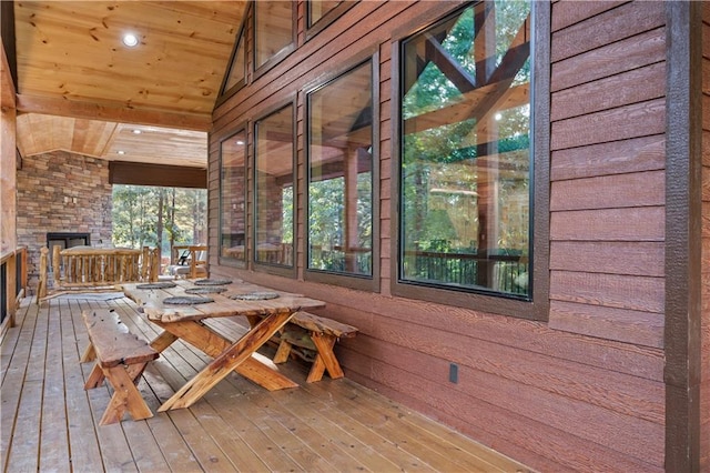 deck featuring an outdoor stone fireplace