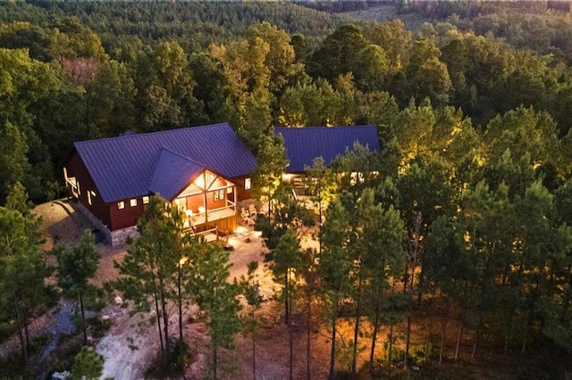 drone / aerial view featuring a wooded view