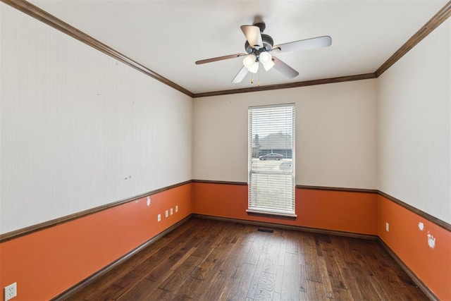 empty room with visible vents, crown molding, ceiling fan, and hardwood / wood-style floors