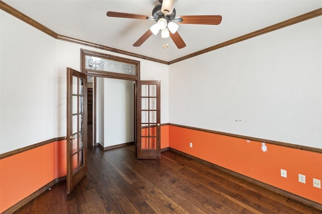 empty room with dark wood finished floors, crown molding, a ceiling fan, and baseboards