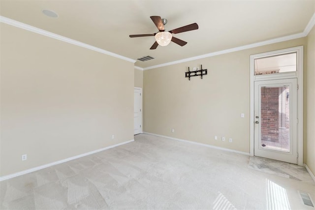 empty room featuring visible vents, light carpet, baseboards, and crown molding