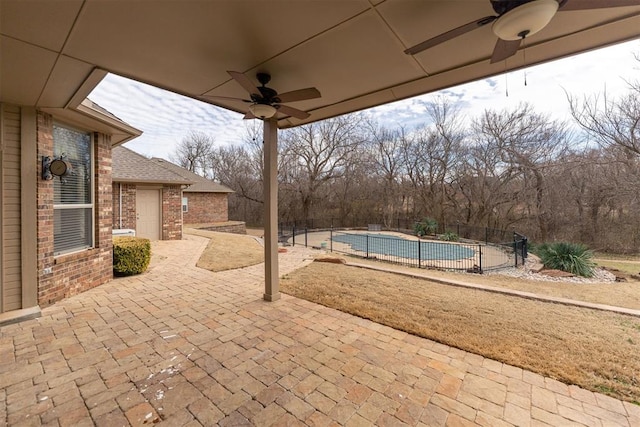 view of patio / terrace featuring fence, a fenced in pool, and ceiling fan