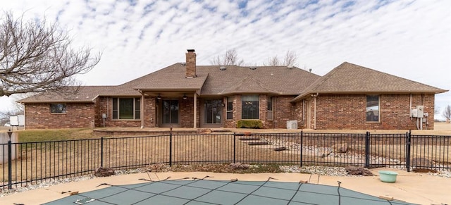 exterior space featuring a patio, fence private yard, brick siding, and a chimney