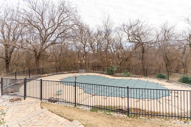 view of swimming pool with a fenced in pool, a patio, and fence