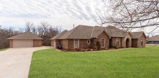 view of front of house with a garage, brick siding, roof with shingles, and a front lawn