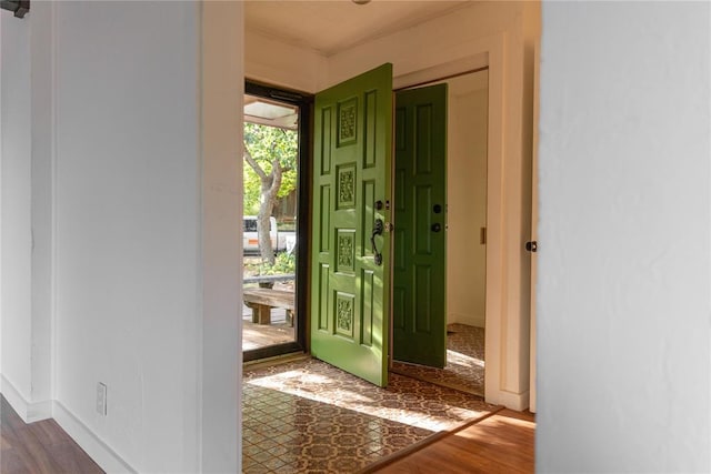 entryway featuring dark wood-style floors and baseboards