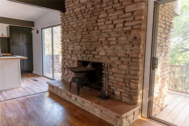 unfurnished dining area with light wood-type flooring and lofted ceiling with beams