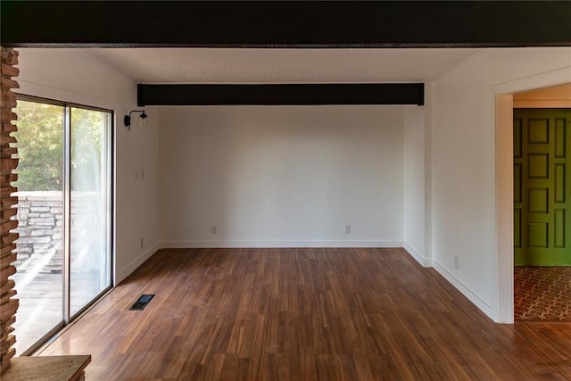 empty room with dark wood-style flooring, beamed ceiling, and visible vents