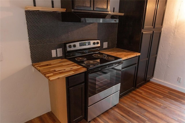 kitchen featuring wood counters, stainless steel electric stove, backsplash, and wood finished floors