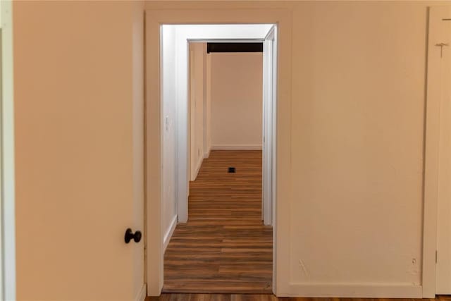 corridor with dark wood finished floors