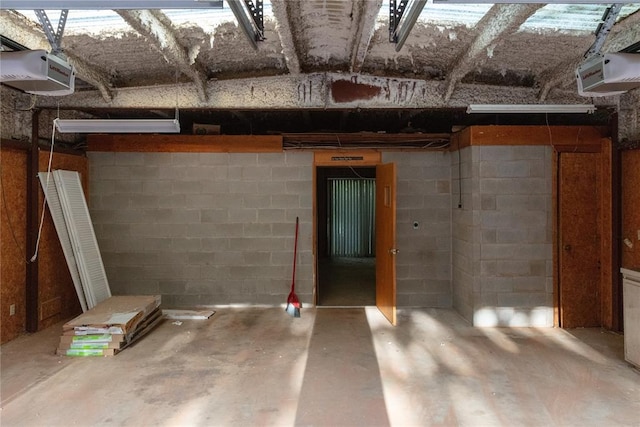 unfinished basement featuring concrete block wall