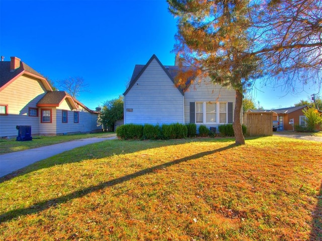 view of side of home with a yard