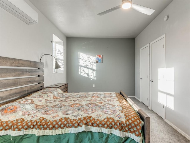 carpeted bedroom featuring ceiling fan, baseboards, and a wall mounted air conditioner