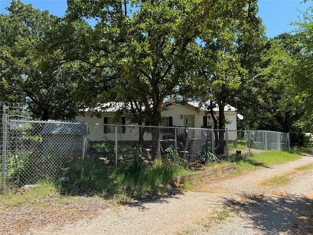 view of yard featuring fence and driveway