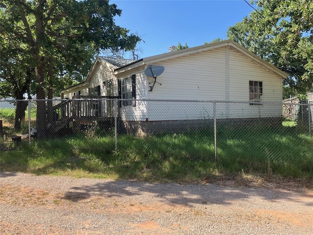 view of side of home featuring fence