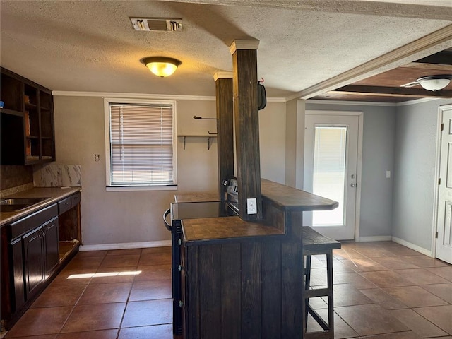 kitchen featuring visible vents, dark countertops, a breakfast bar area, stainless steel electric range, and open shelves